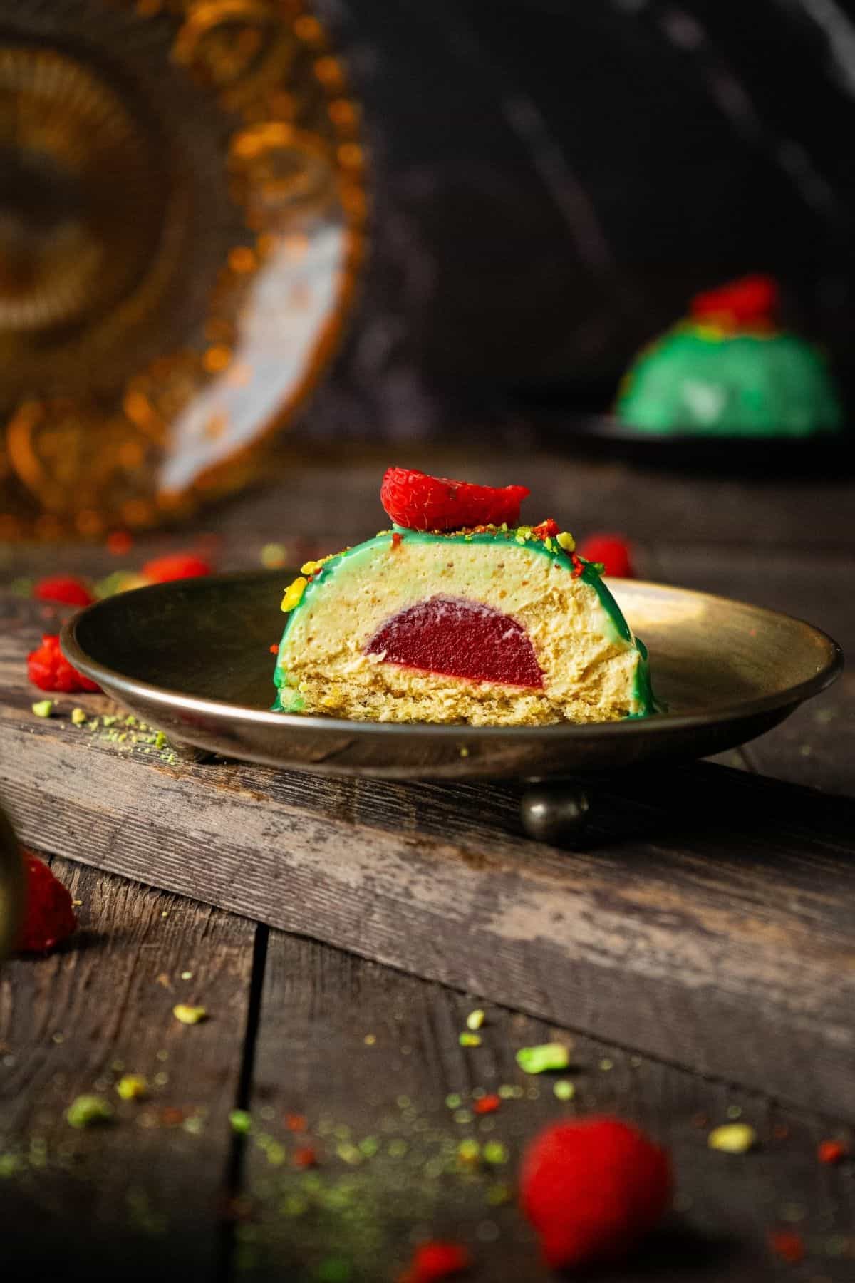 A single plated dessert being sliced open, revealing its layered filling inside.