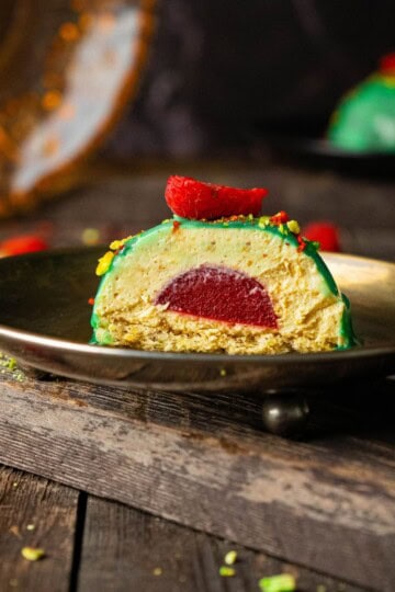 A single plated dessert being sliced open, revealing its layered filling inside.