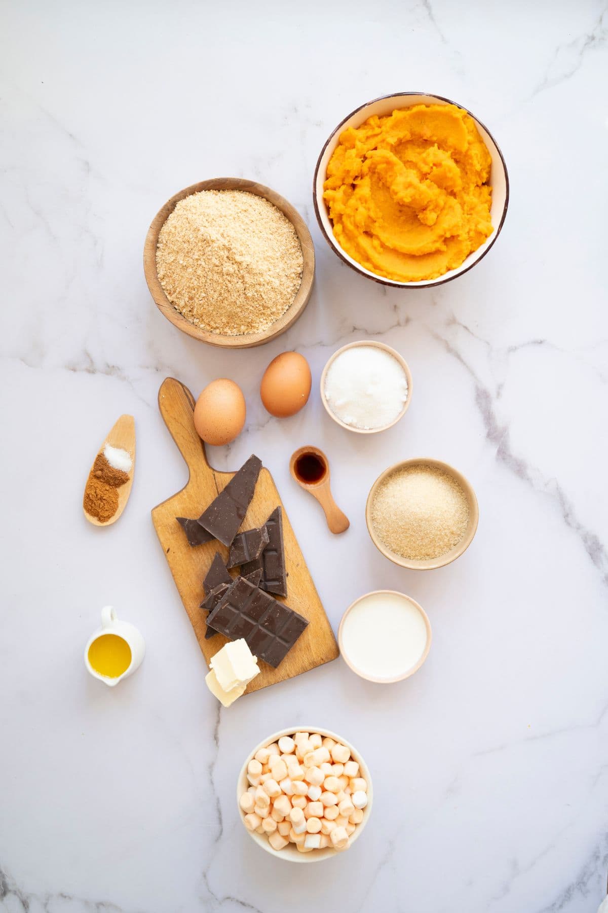 Ingredients neatly arranged on a countertop, ready for making sweet potato pie.
