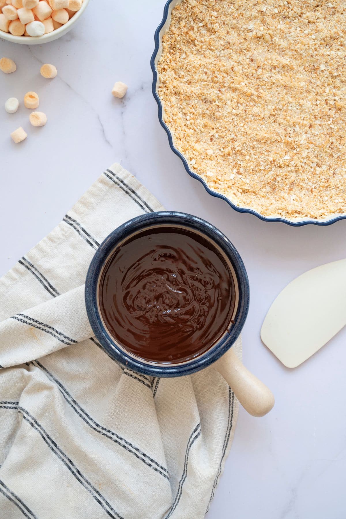 Dark chocolate melted in a small bowl, ready to be used in the pie.