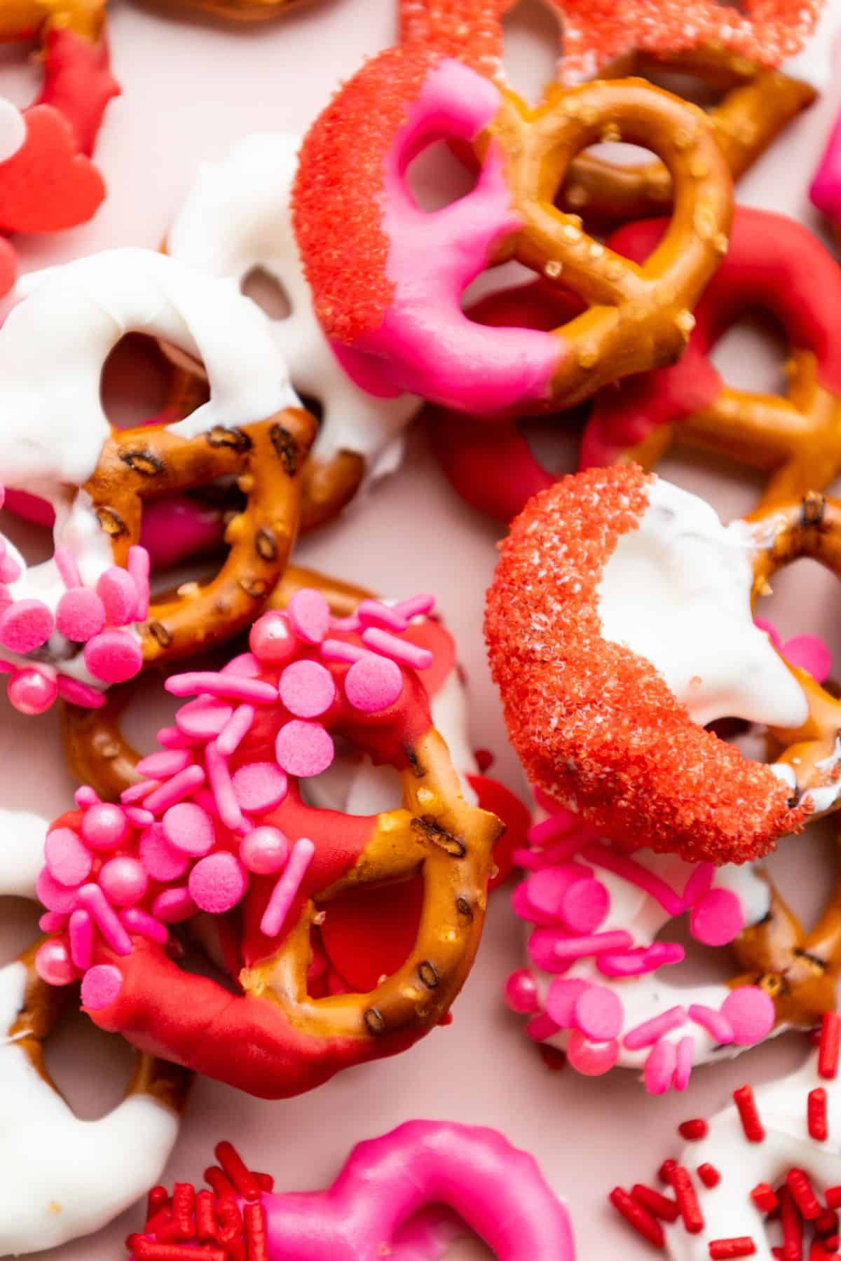 Delicious Valentine’s Day pretzels decorated with pink, red, and white chocolate, topped with colorful sprinkles.