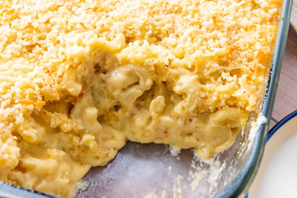 Closer view of baked macaroni and cheese in a baking dish showing the creamy inside.