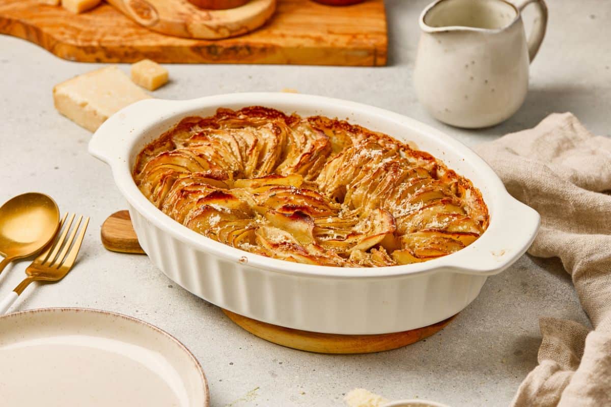 Delicious homemade apple tart with caramelized apple slices in a baking dish. Perfect for dessert or tea.