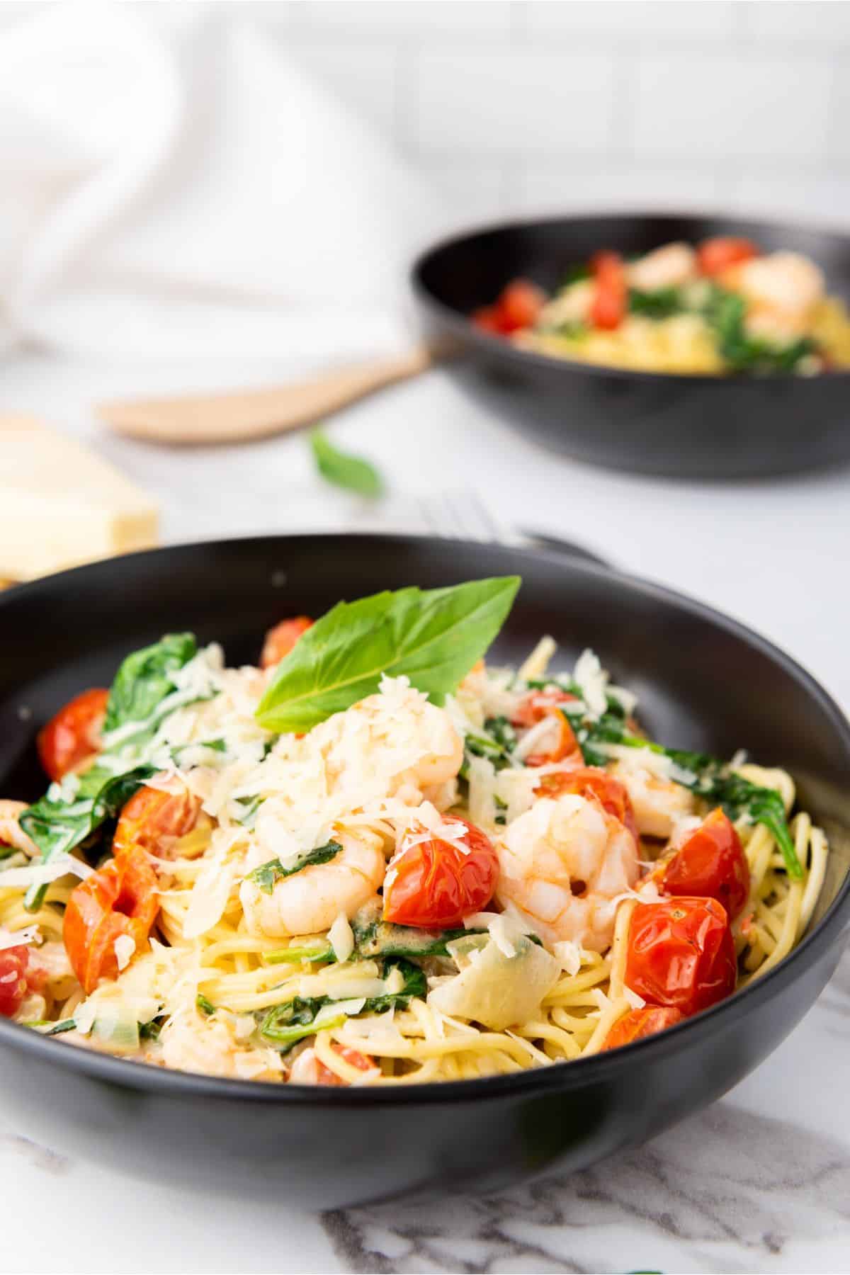 Fresh shrimp pasta dish topped with cherry tomatoes, basil, and Parmesan cheese. Perfectly cooked and flavorful.
