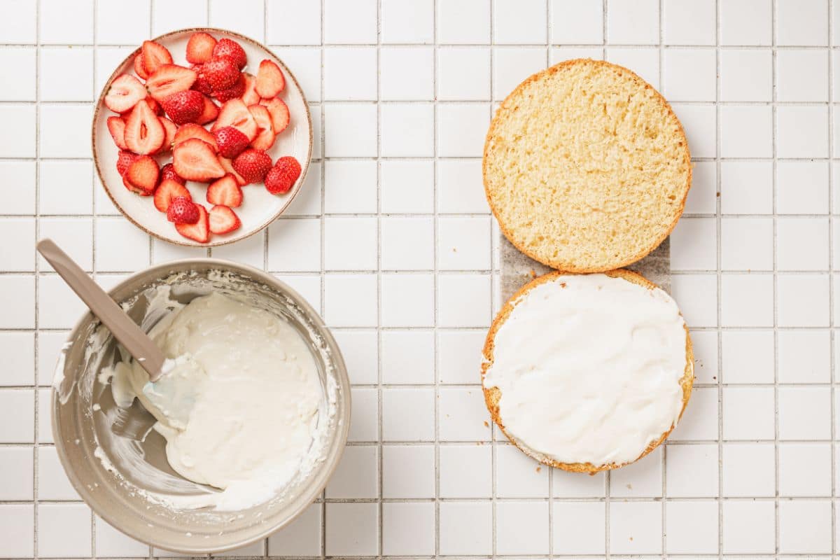Fresh strawberries, whipped cream, and sponge cake ready for dessert.