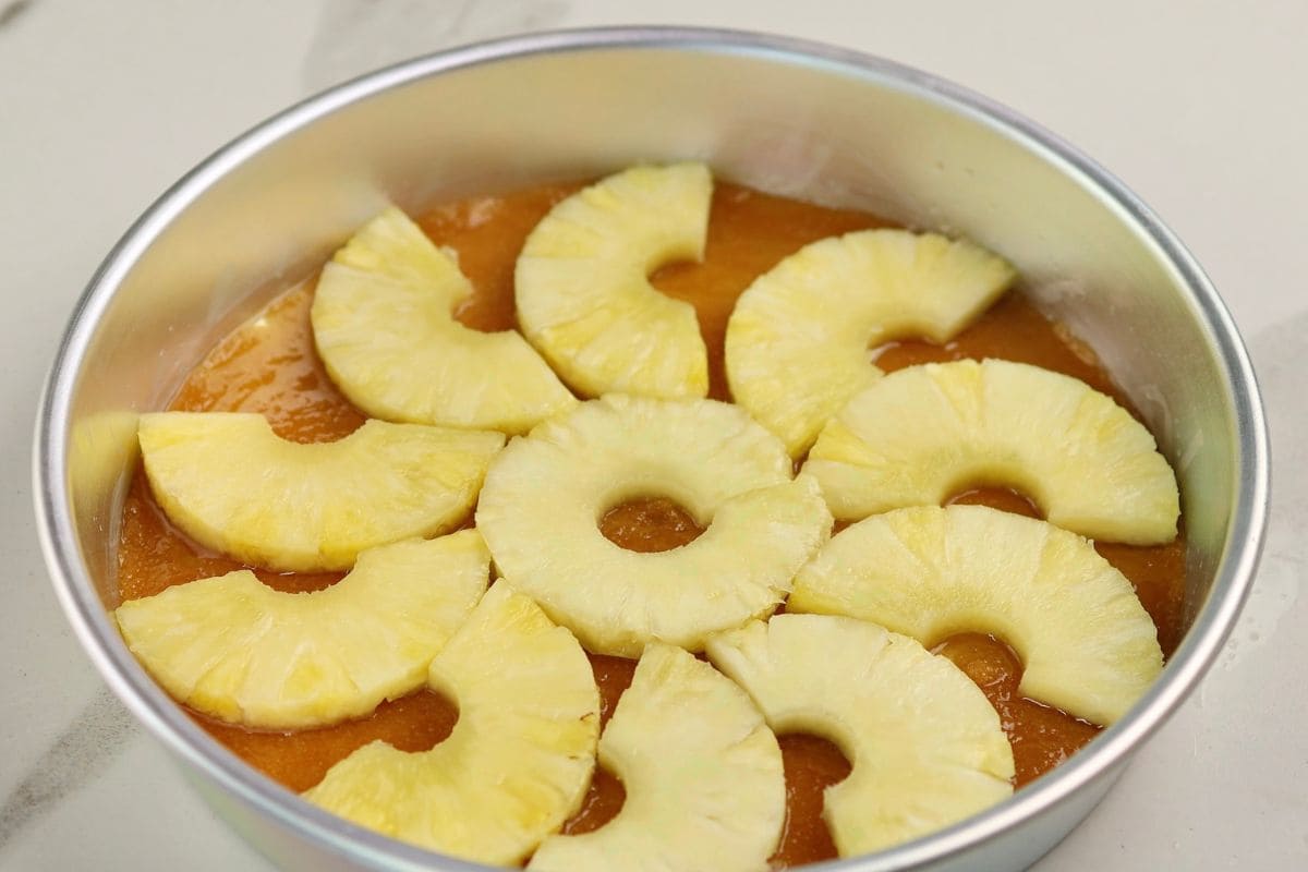 Fresh pineapple slices on top of a vibrant fruit tart.