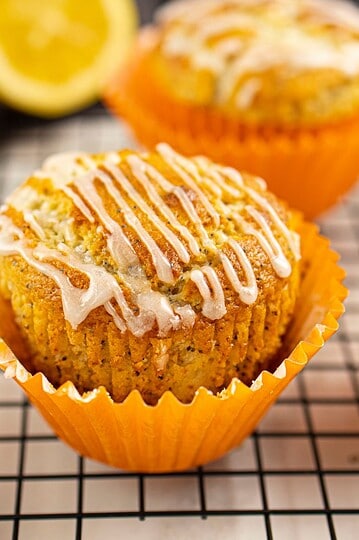 Freshly baked pumpkin muffins topped with drizzled cream cheese icing and spices. Perfect for fall snacks and holiday desserts.