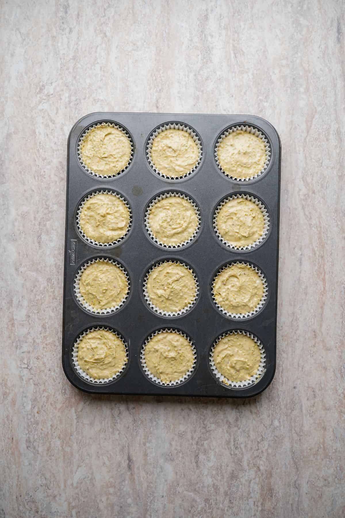 Close-up of cupcake batter in muffin tin for baking.