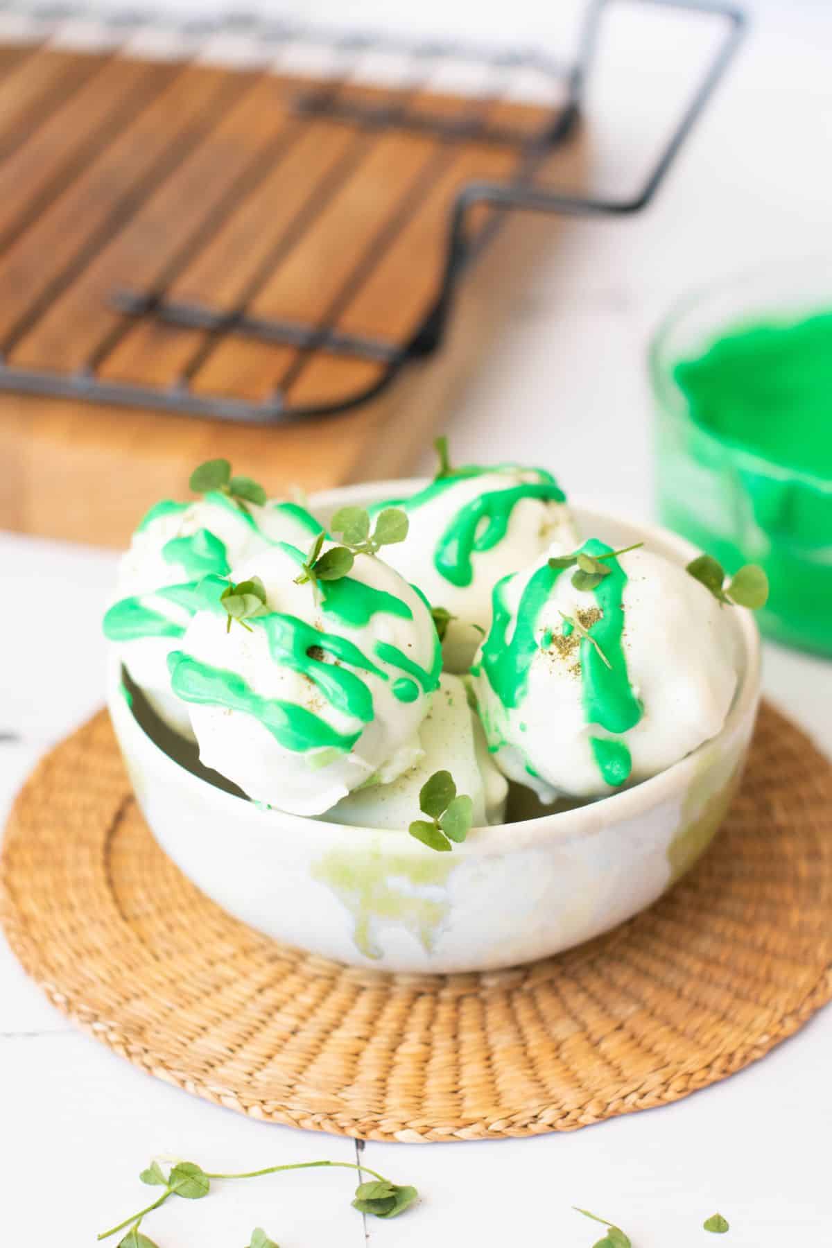 Delicious vanilla ice cream topped with green syrup and garnished with microgreens. Perfect for St. Patrick's Day celebrations.