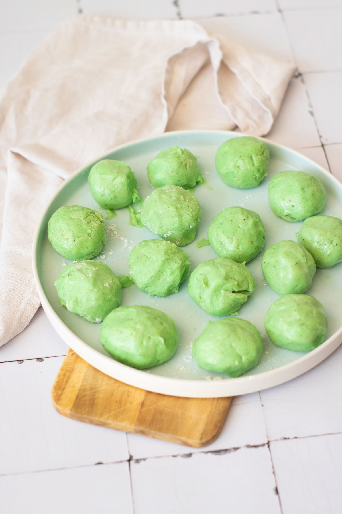 Bright green homemade avocado cookies with a rustic appearance and a hint of flour.