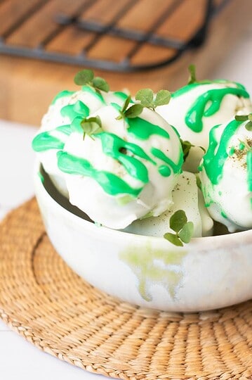 Delicious green and white dessert with sprigs of tiny leaves, perfect for St. Patrick's Day celebrations.