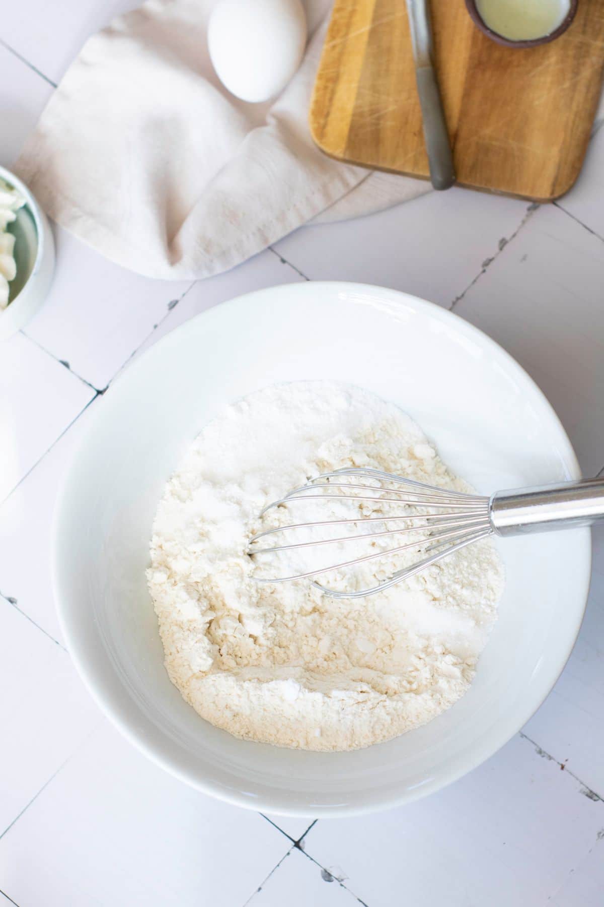 Freshly prepared flour mixture for baking on a white kitchen counter.