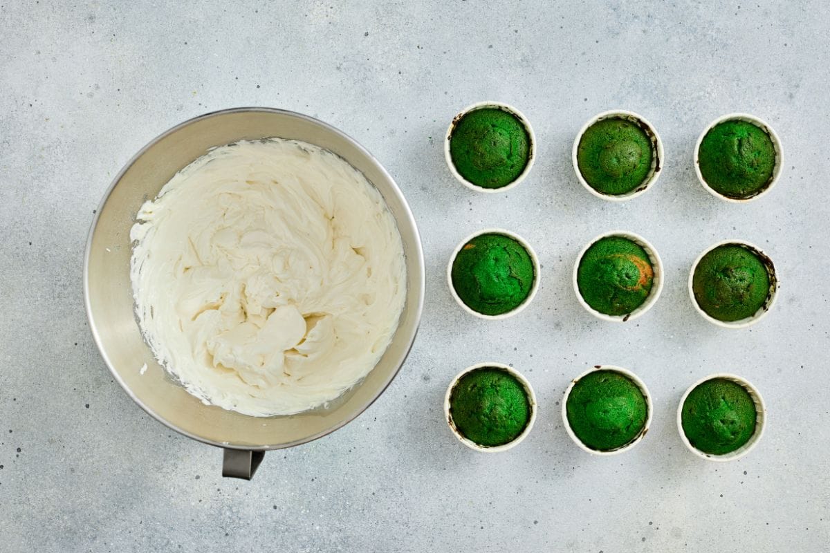 Bright green cupcake toppers with white frosting, perfect for St. Patrick's Day treats.