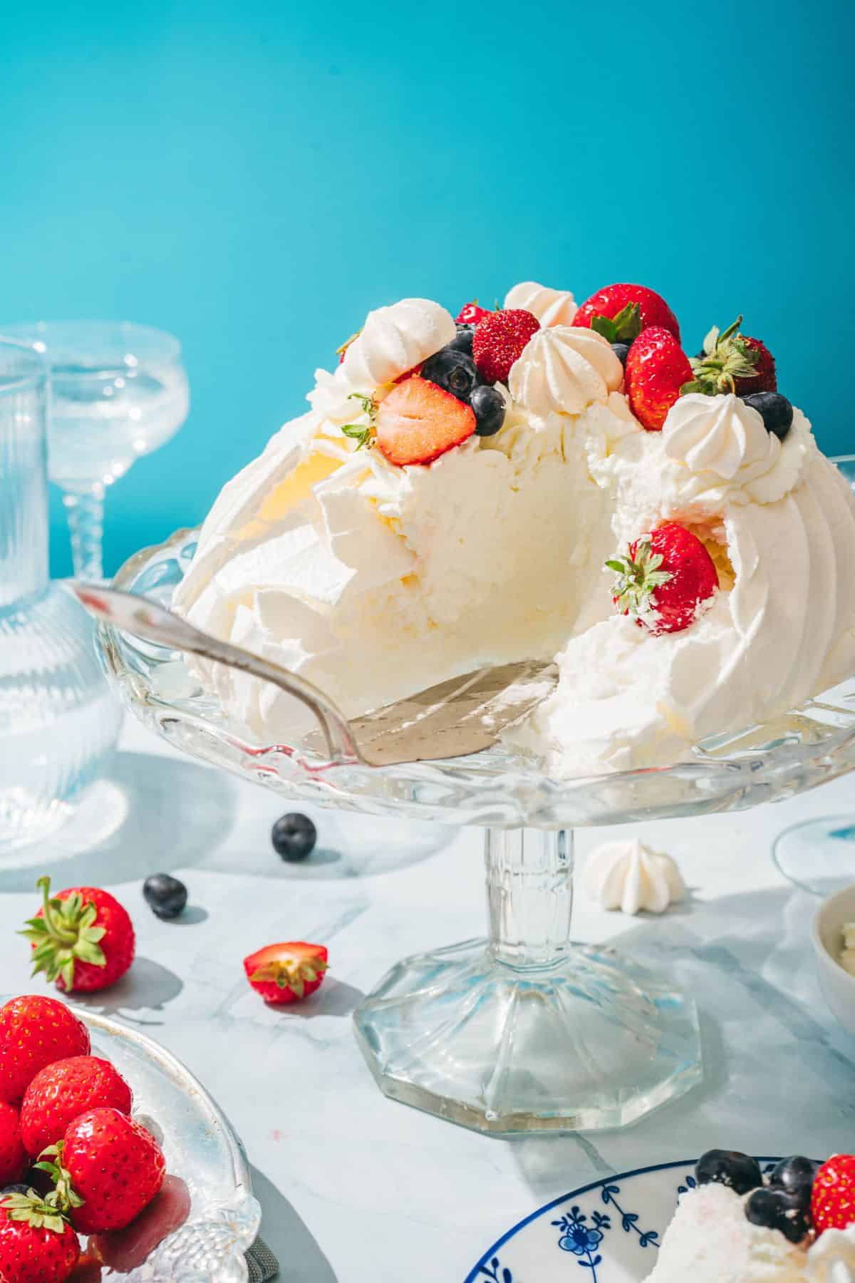 Delicious, fluffy berry cake topped with strawberries, blueberries, and whipped cream, perfect for spring celebrations.