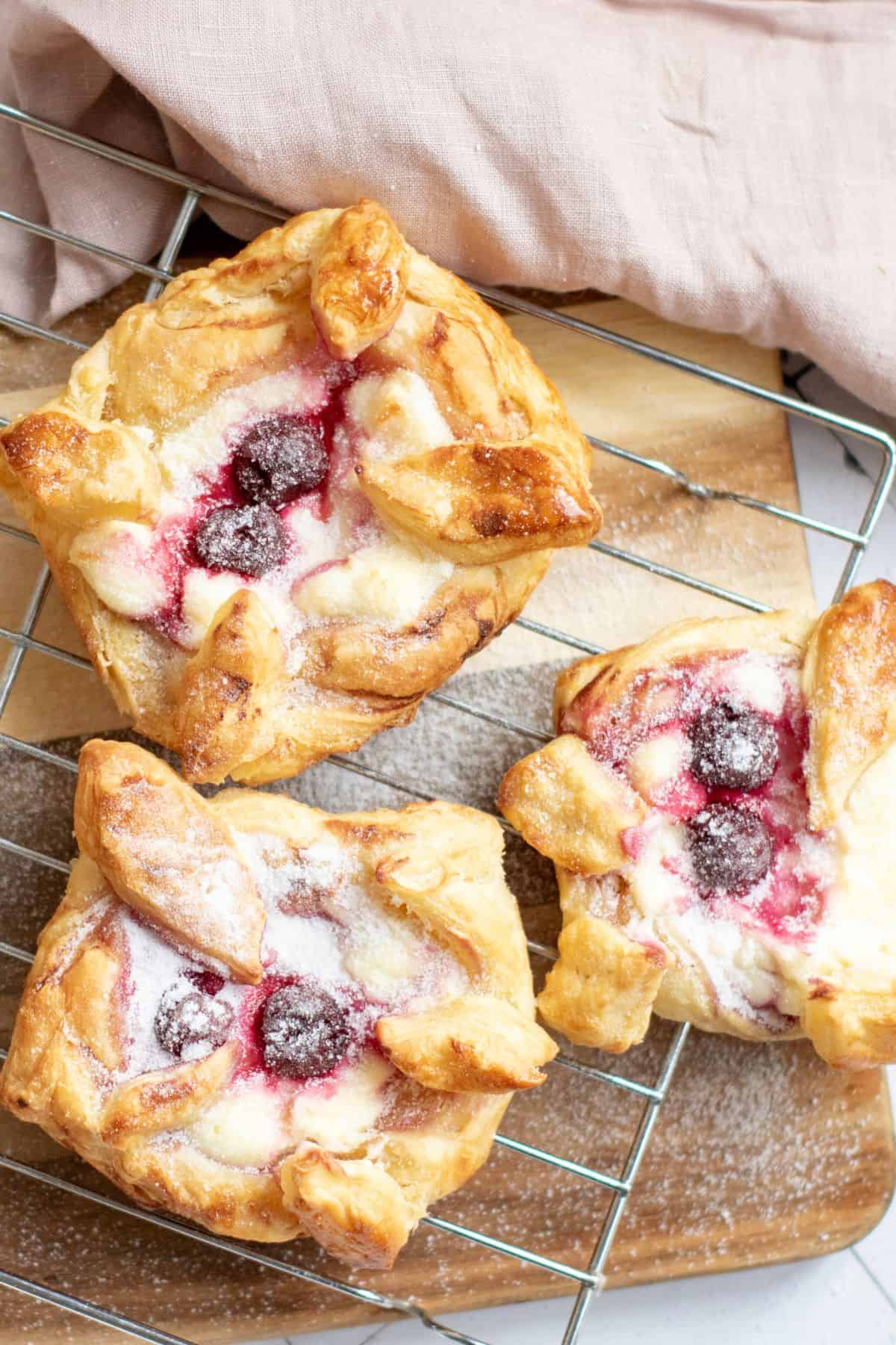 Creamy cherry Danish pastries with flaky crusts and fresh fruit, ideal for spring brunch or Easter treats.