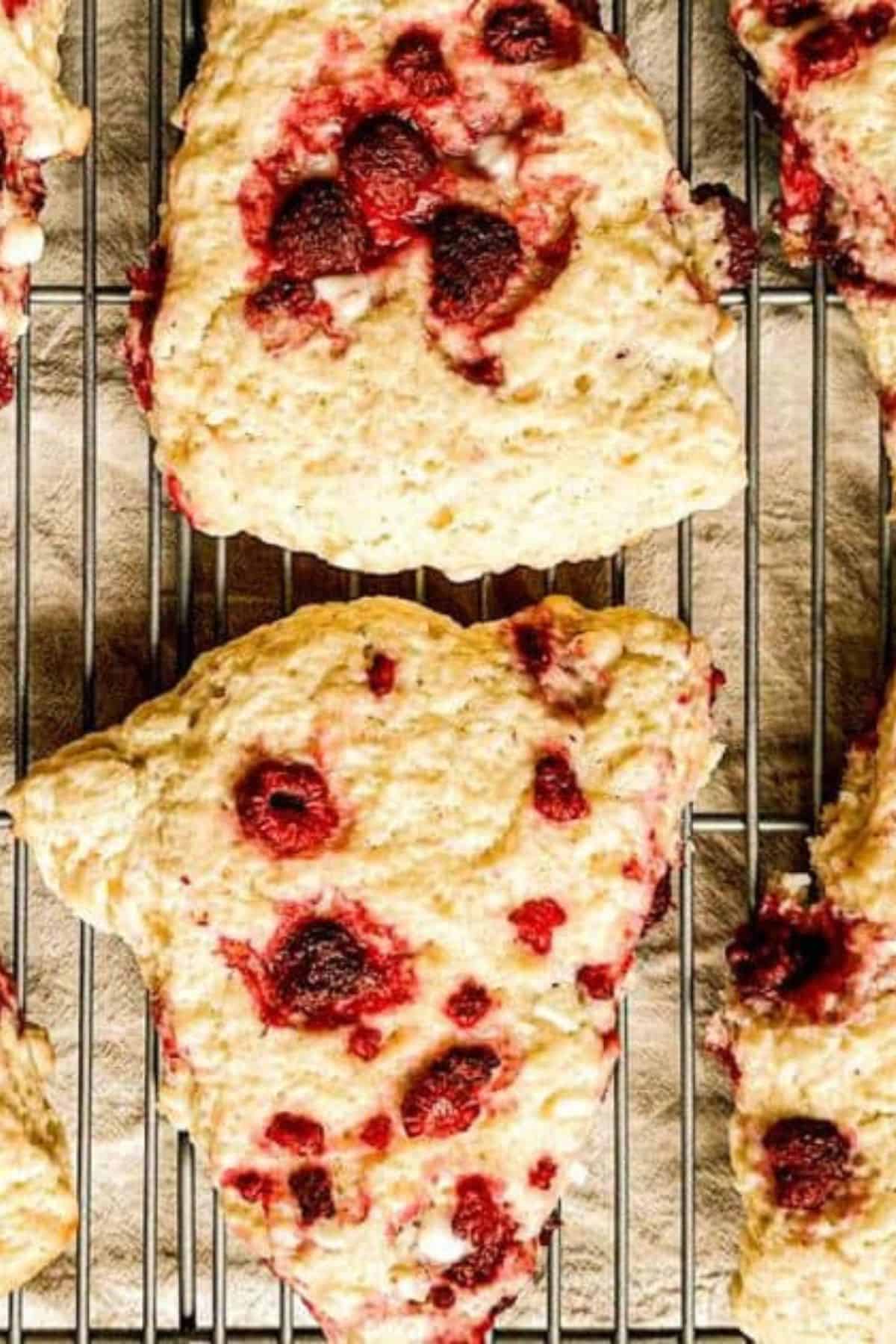 Delicious homemade berry shortcake with strawberries, raspberries, and cream on a cooling rack. Perfect spring treat for brunch or tea time.