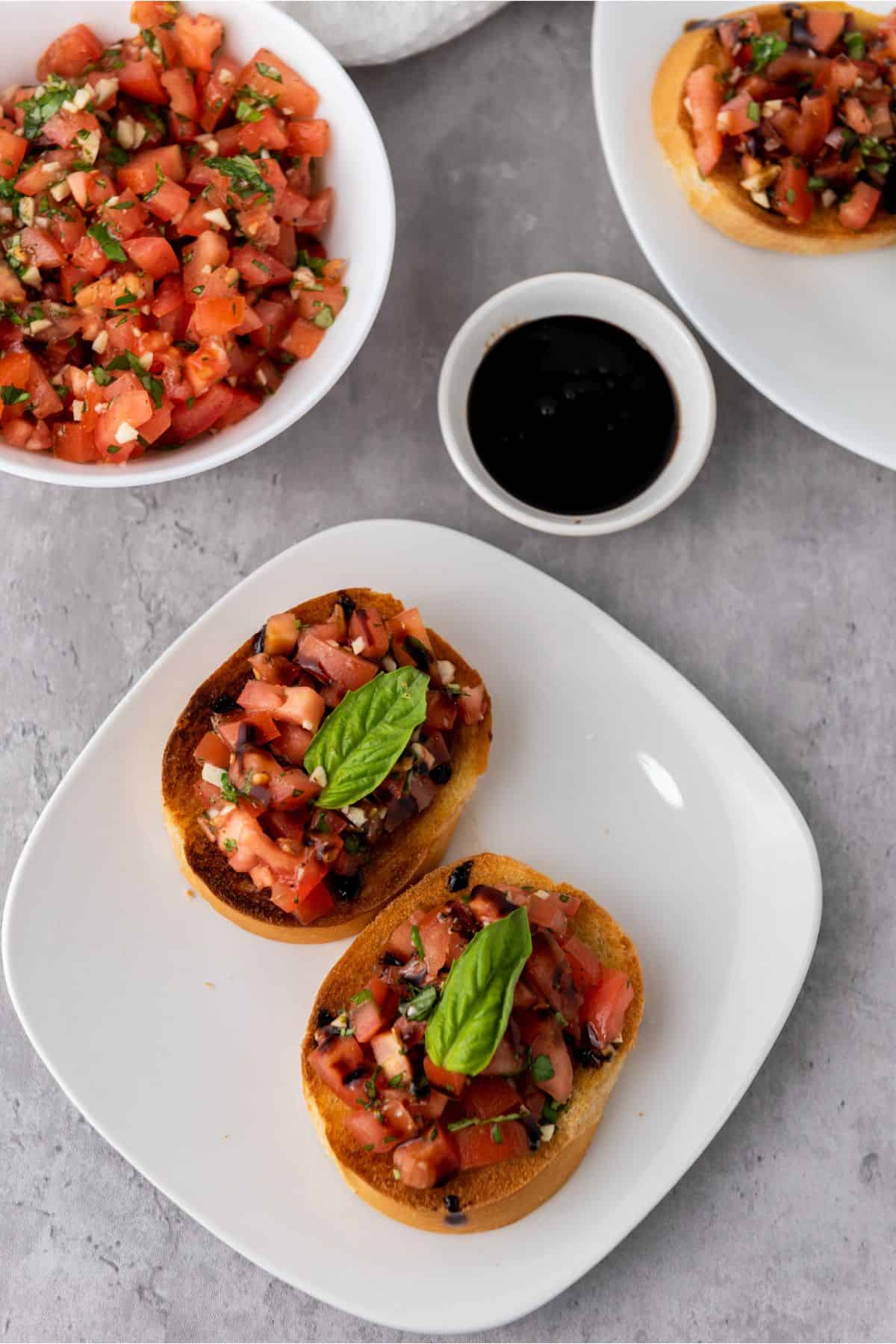 Delicious bruschetta topped with chopped tomatoes, garlic, basil, and balsamic glaze on toasted baguette slices.