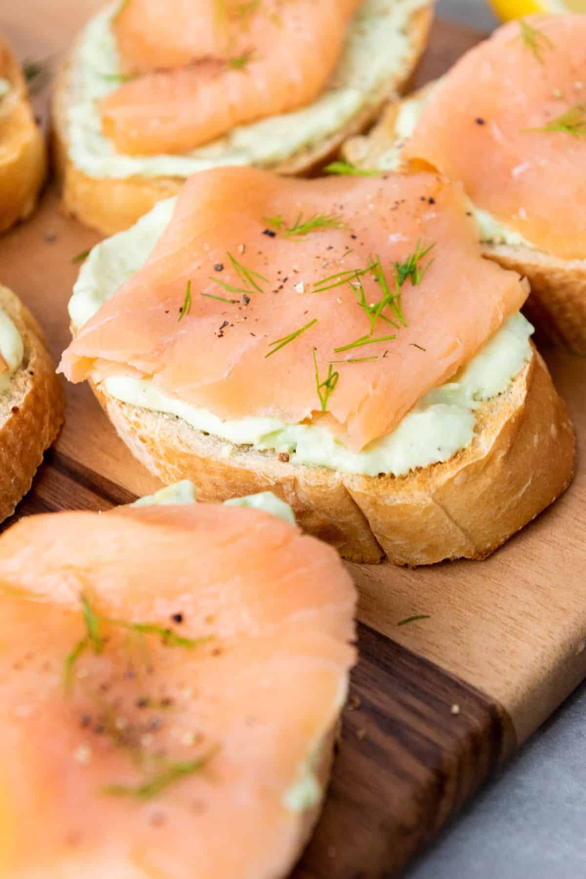 Smoked salmon crostini topped with cream cheese, dill, and black pepper for a tasty Easter snack.
