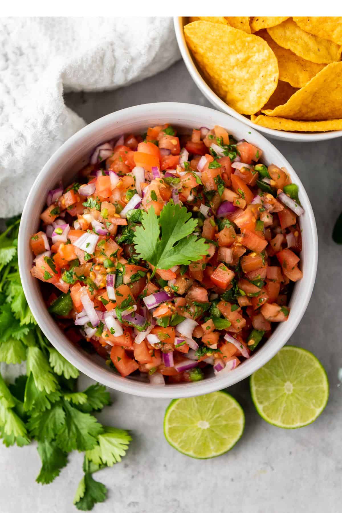 Colorful tomato salsa dip with chopped vegetables, cilantro, and lime, perfect for Easter appetizers and party snacks.