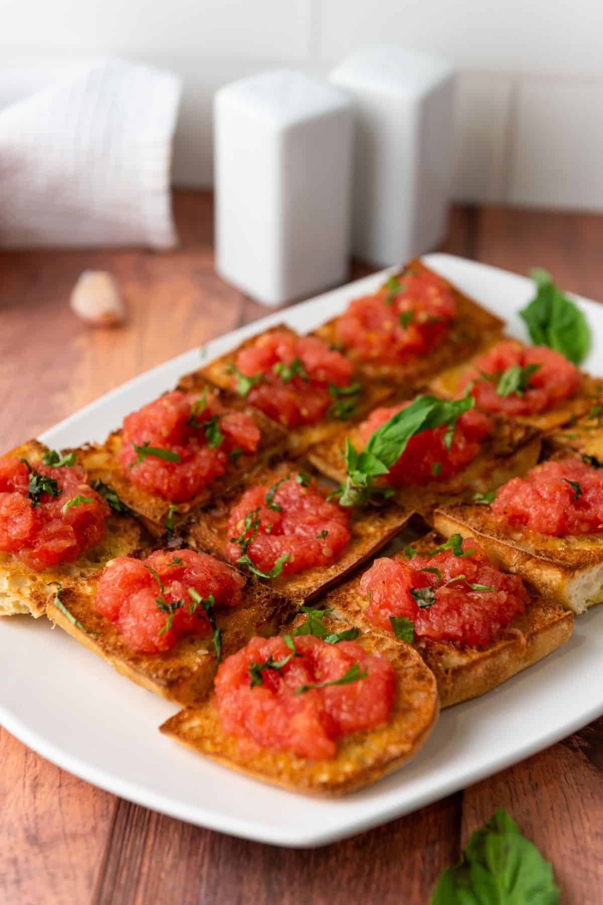 Vibrant tomato bruschetta appetizers on toasted bread, garnished with fresh basil and herbs. Perfect for Easter snacking.