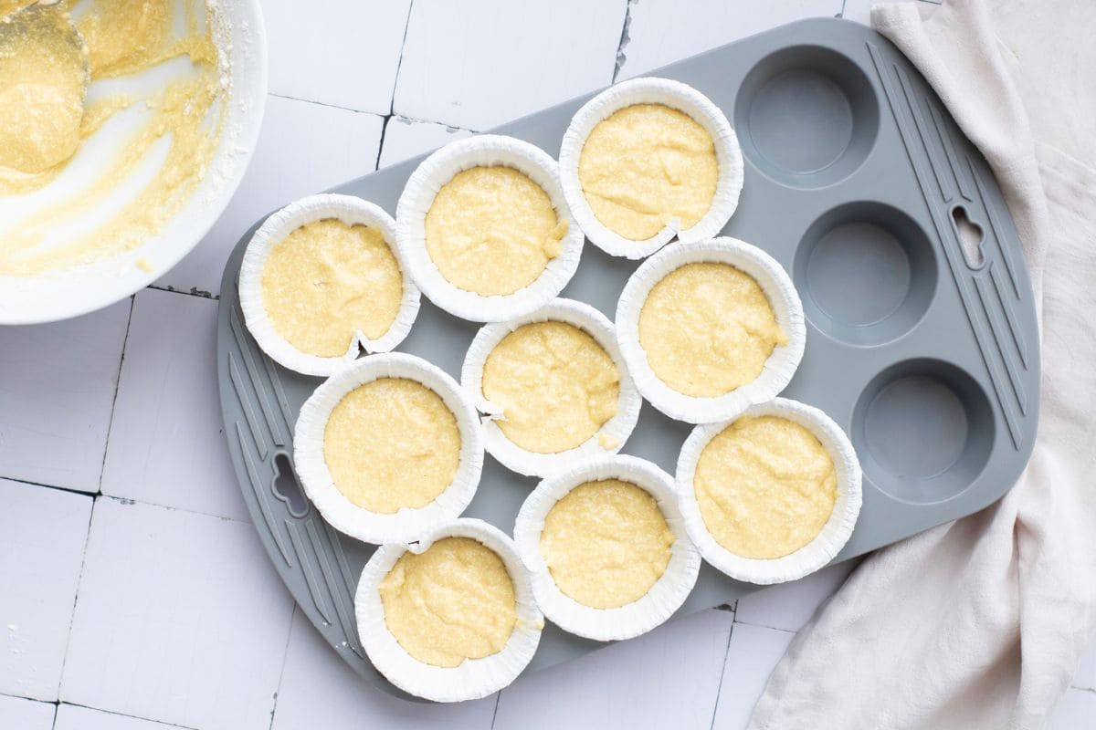 Freshly prepared cupcake liners filled with batter for Saint Patrick's Day cupcakes.